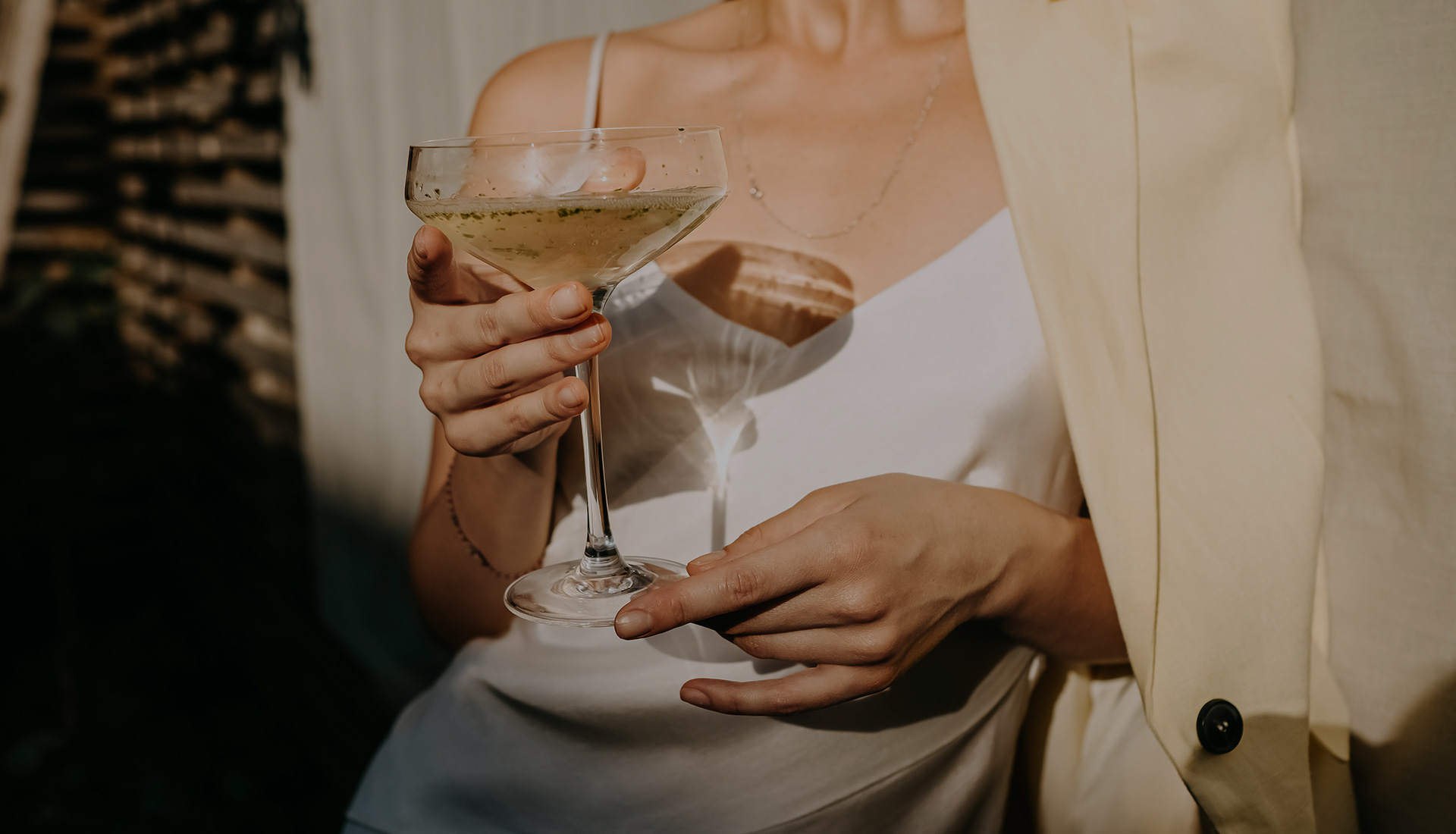 Woman in white holding cocktail | TheHawthornNH