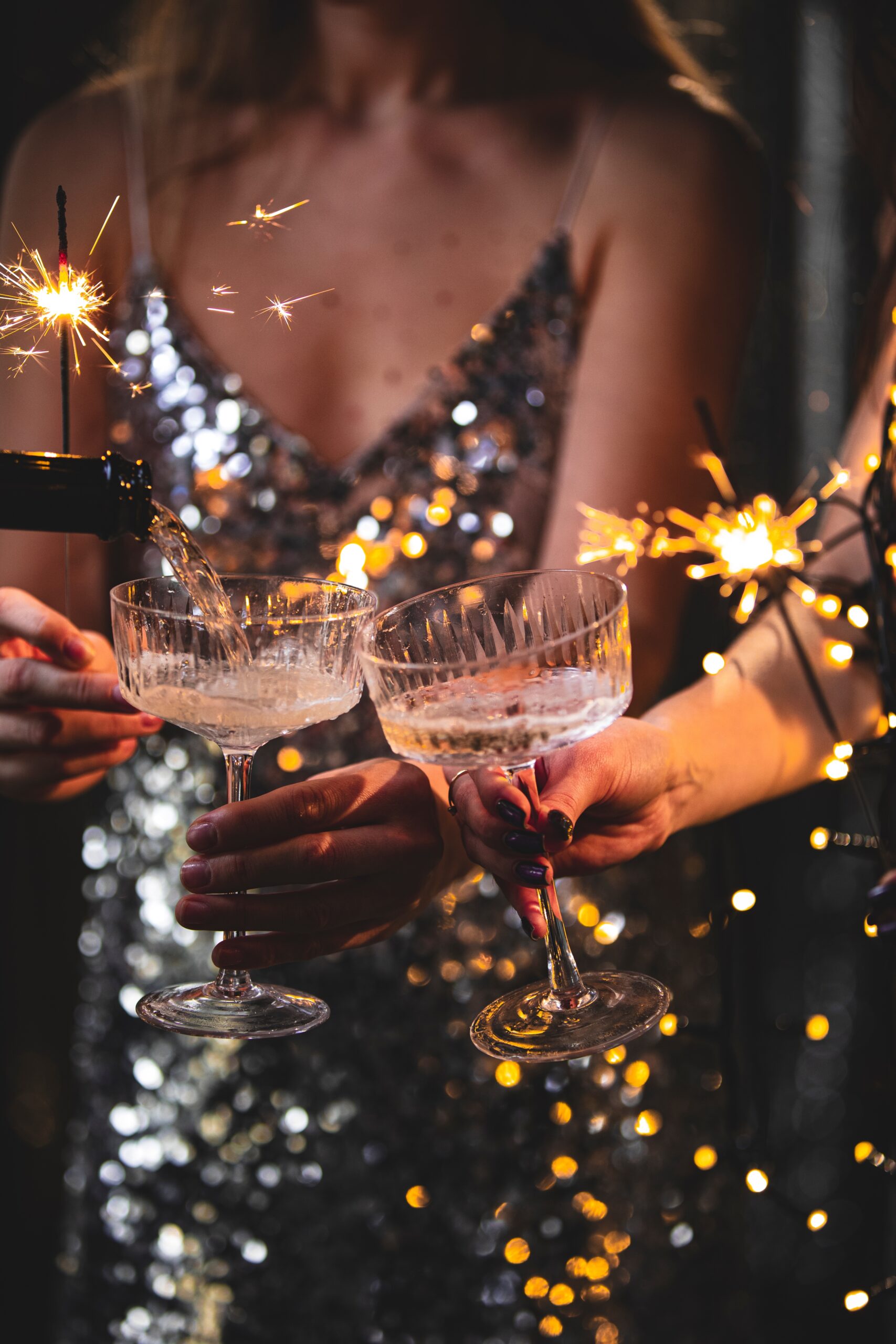 women drink champagne with sparklers at an event