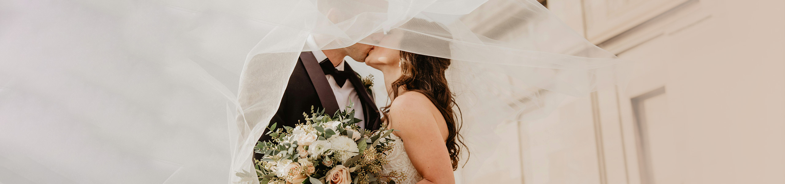 Couple kissing under veil