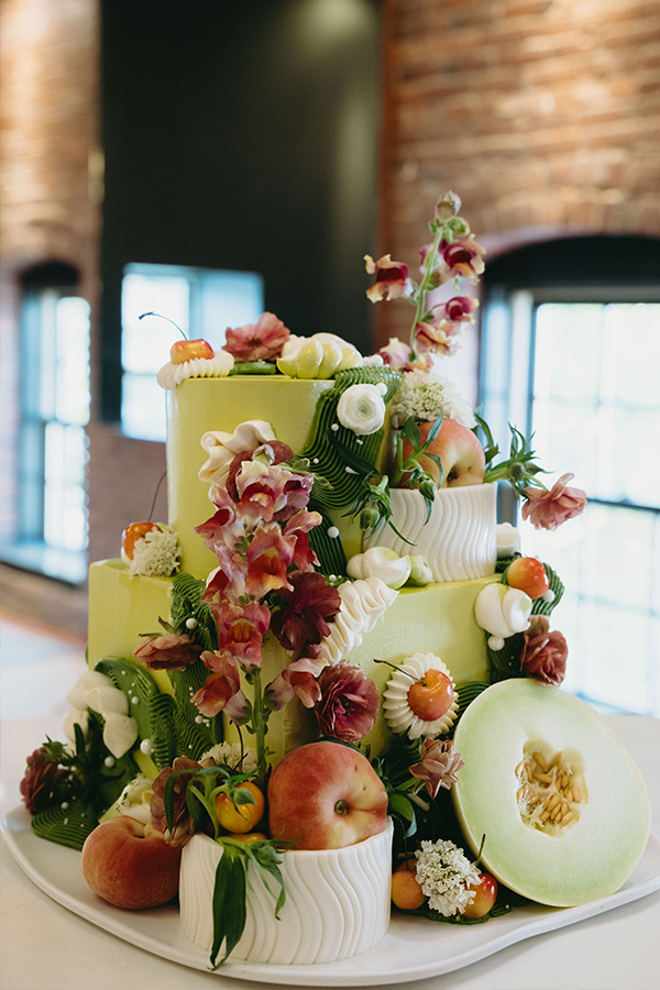 wedding cake with fruit and florals