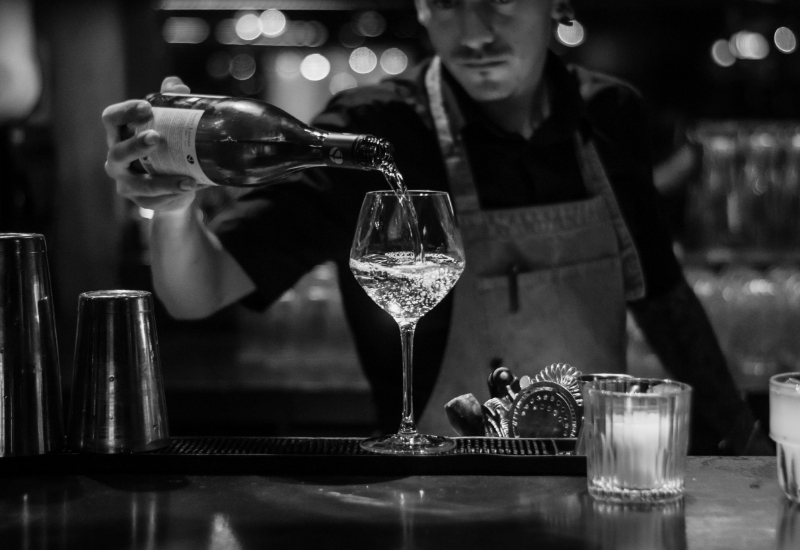 Bartender pouring a glass of wine