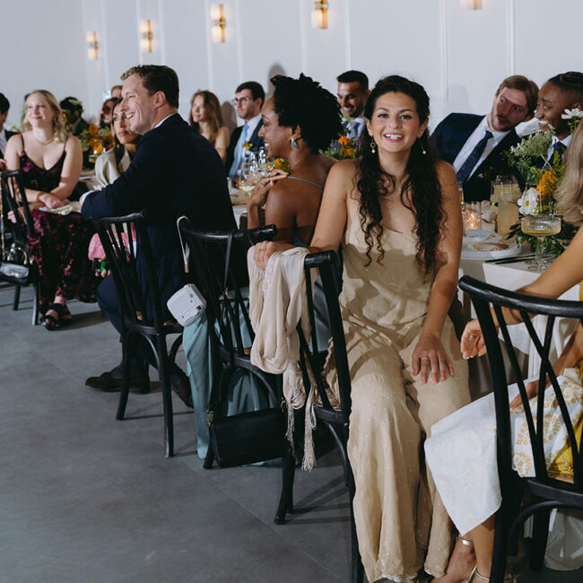 Wedding guests sitting at tables watching the dance floor