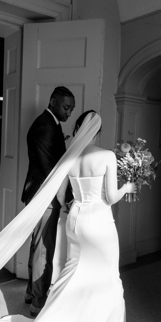 Bride and groom walking through doorway