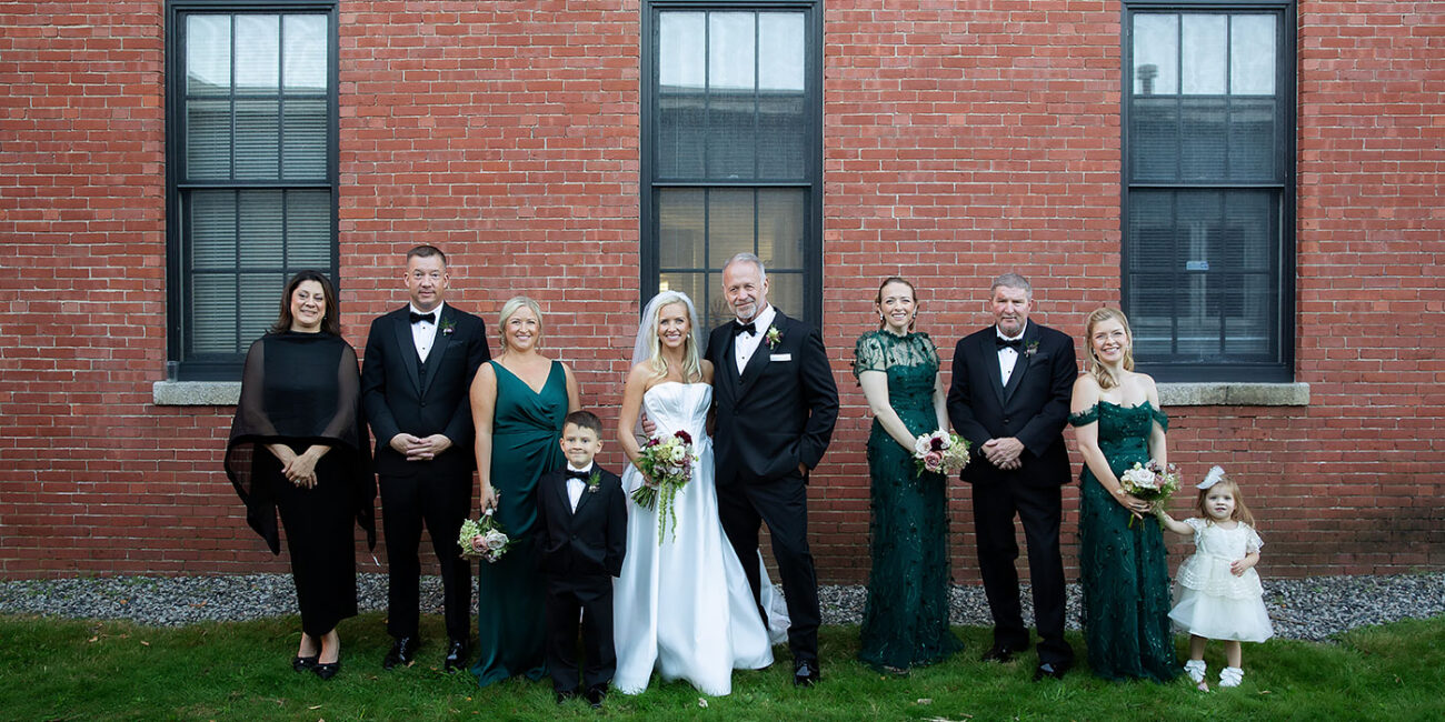 Wedding party posing outside The Hawthorn brick exterior