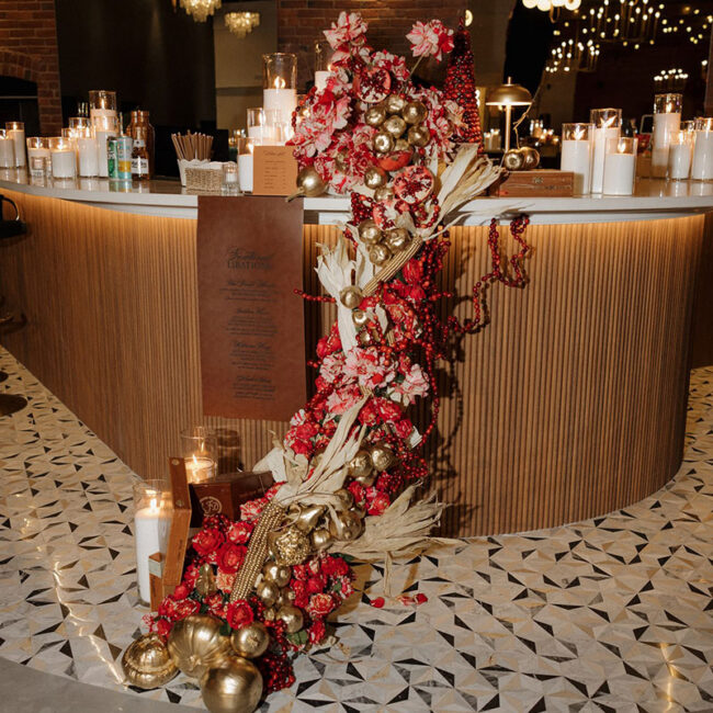 Red graphic and floral decor draping off bar at The Hawthorn