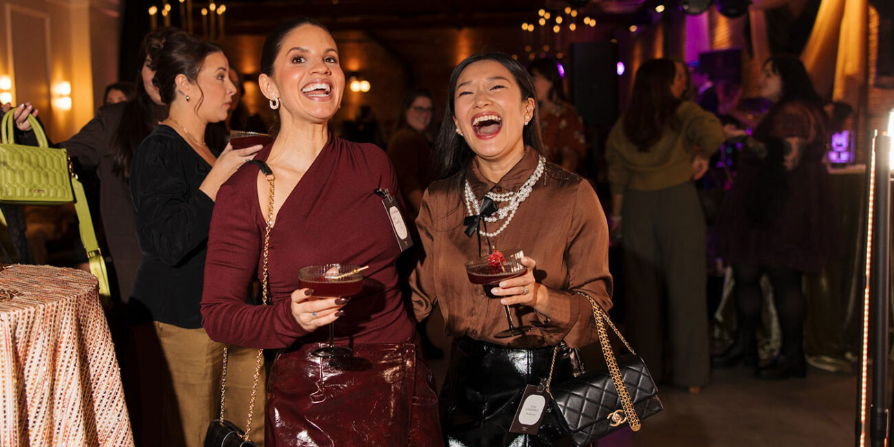 Two women laughing at event