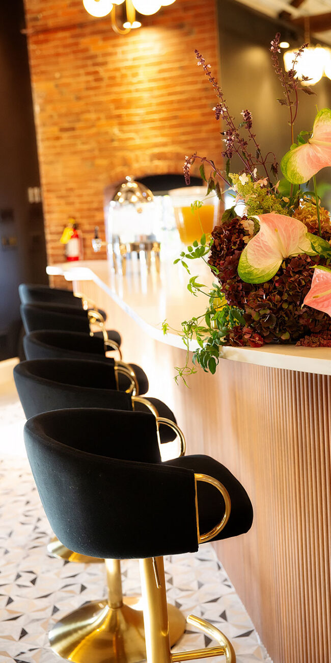 Bar stools and elegant bar with florals