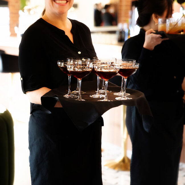 Female serve with tray of drinks