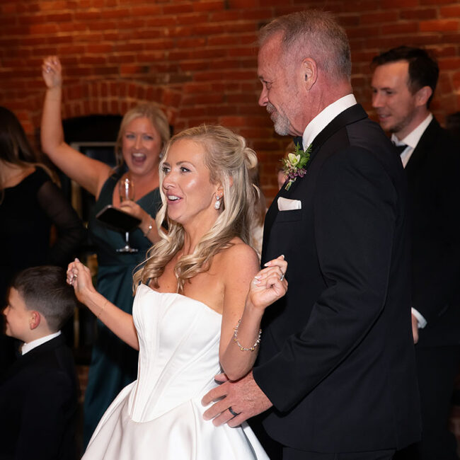 Bride and groom dancing with guests