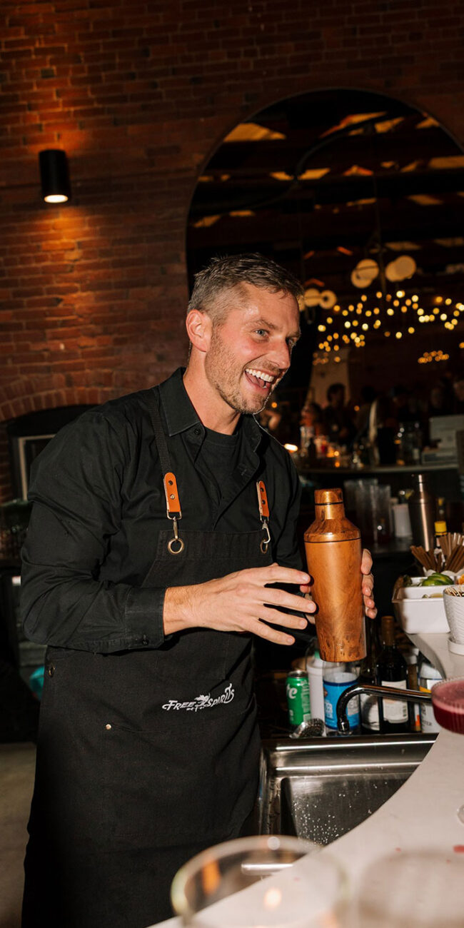 Male bartender making cocktail