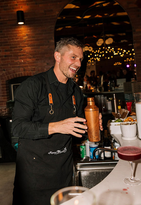 Bartender mixing drinks with smile