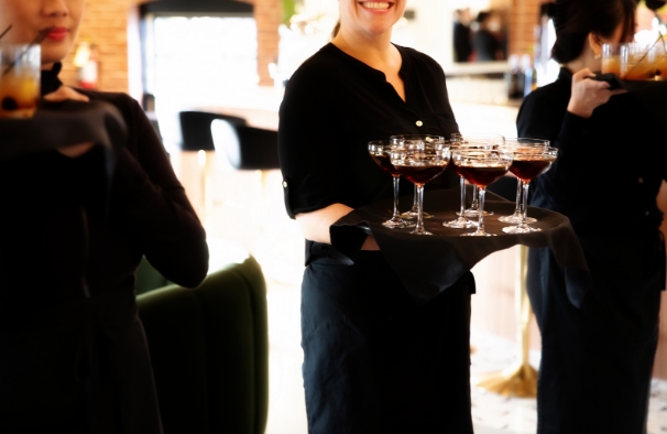 Server carrying tray of espresso martinis