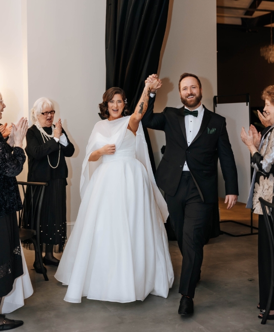 Couple holding hands during entrance