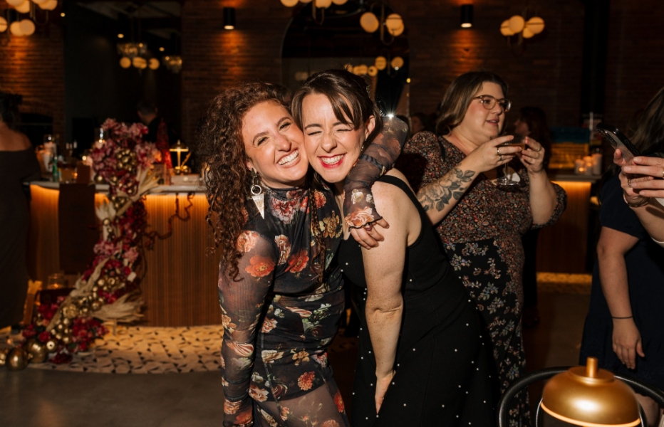 Two woman smiling with arms around each other at The Hawthorn